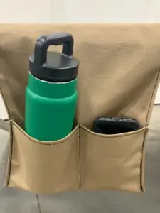 Green bottle and phone in tan pouch