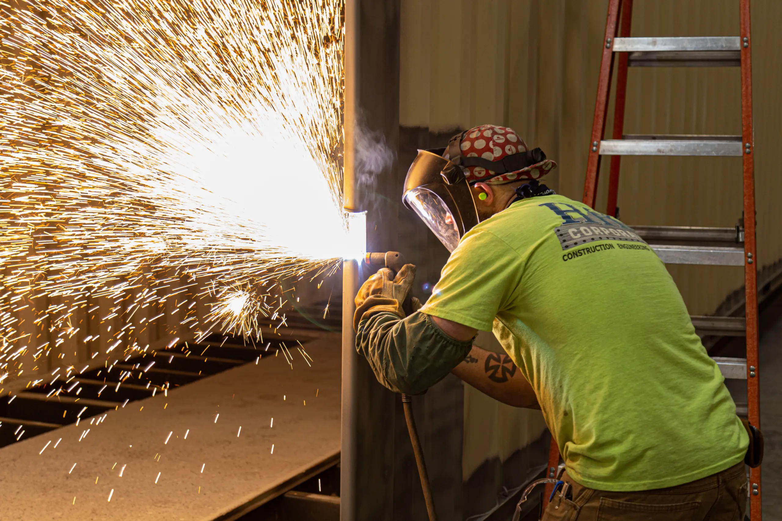 Welder cutting metal with sparks flying