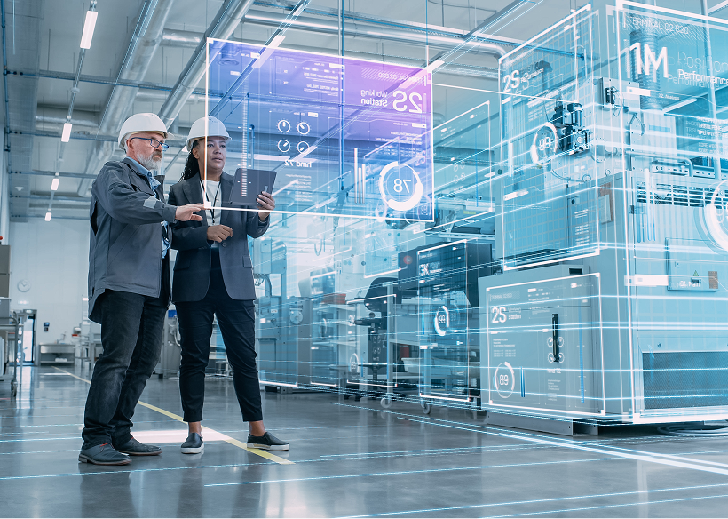Workers reviewing virtual industrial schematics