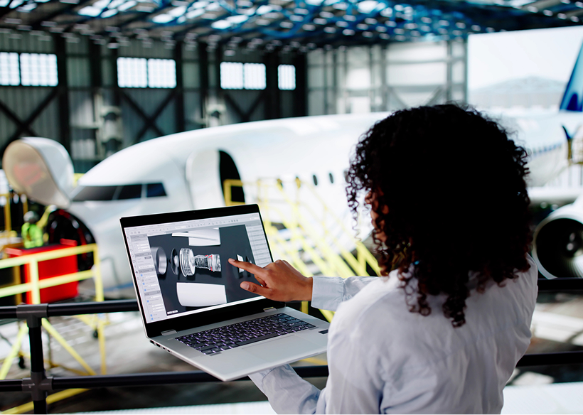 Engineer analyzing airplane design on laptop