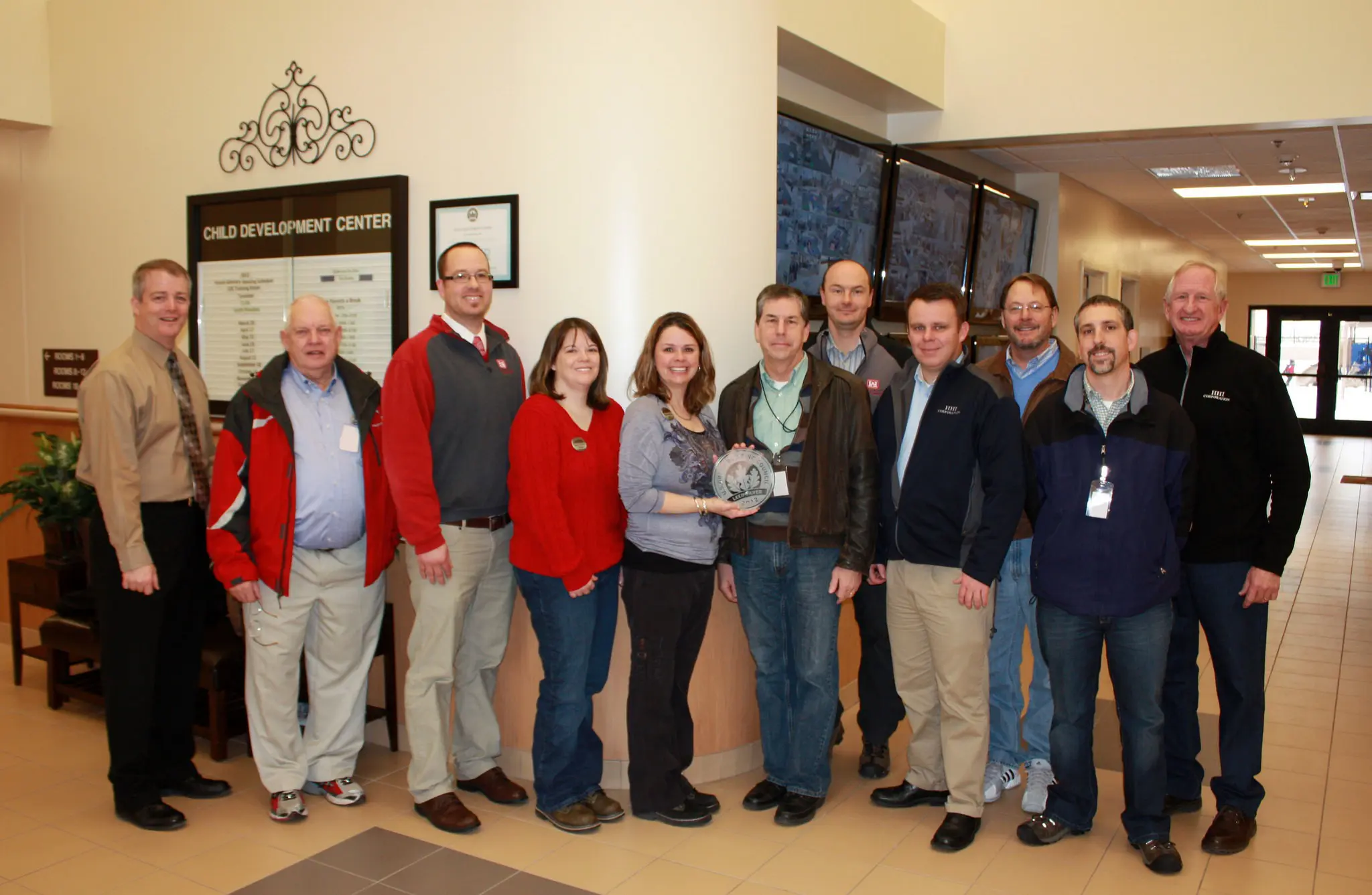 Group of people standing in a lobby.