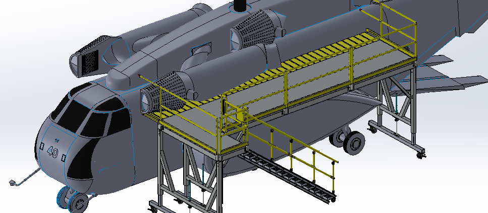 Industrial platform with safety railings and stairs beside machinery.