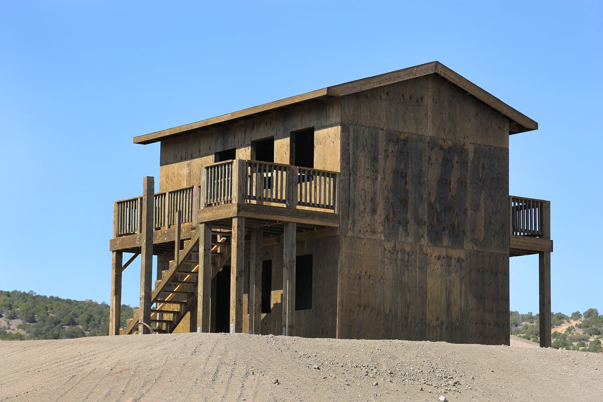Wooden house on stilts in desert