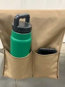 Green bottle and phone in tan pouch