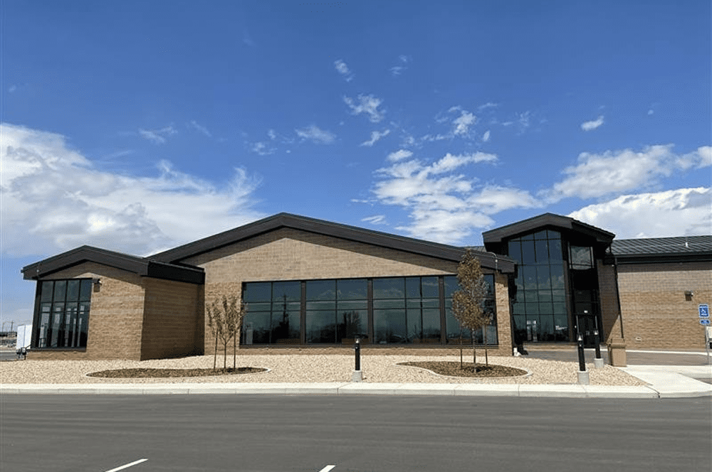 Modern brick building with large glass windows.