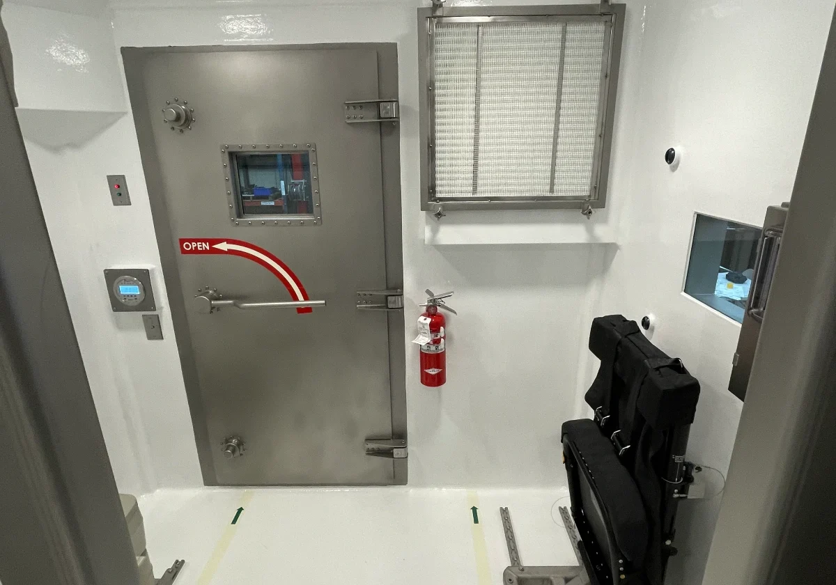Secure room with door and seating.
