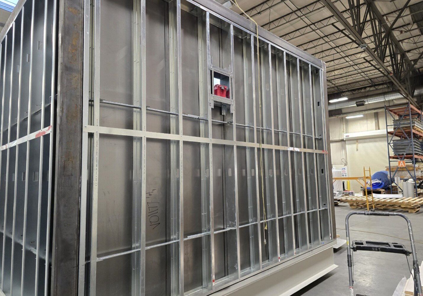 Large metal frame inside an industrial warehouse.